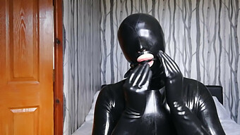 Latex-Clad Bondage Enthusiast Gagged And Gas Masked